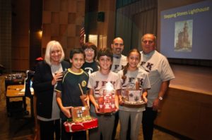John F. Kennedy Elementary School students, pictured here with Town Supervisor Judi Bosworth, Great Neck Historical Society President Alice Kasten and Park Commisioner Bob Lincoln, hold up their model lighthouses. (Photo courtesy of Alice Kasten)