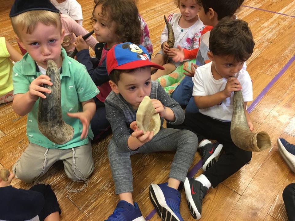 Silverstein Hebrew Academy preschool students practice blowing the Shofar to celebrate Rosh Hashanah. They learned the symbolic significance of blowing the shofar as part of the school’s mission to provide a well-rounded education in Jewish cultural heritage as well as an advanced secular education. (Photo courtesy of Zimmerman/Edelson)