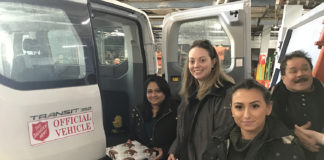Employees Alice Joseph, Patricia Reilly and Valentina Faraci hand off presents to the Salvation Army from Transervice Long Island’s corporate headquarters in Lake Success. (Photo courtesy of Transervice Logistics)
