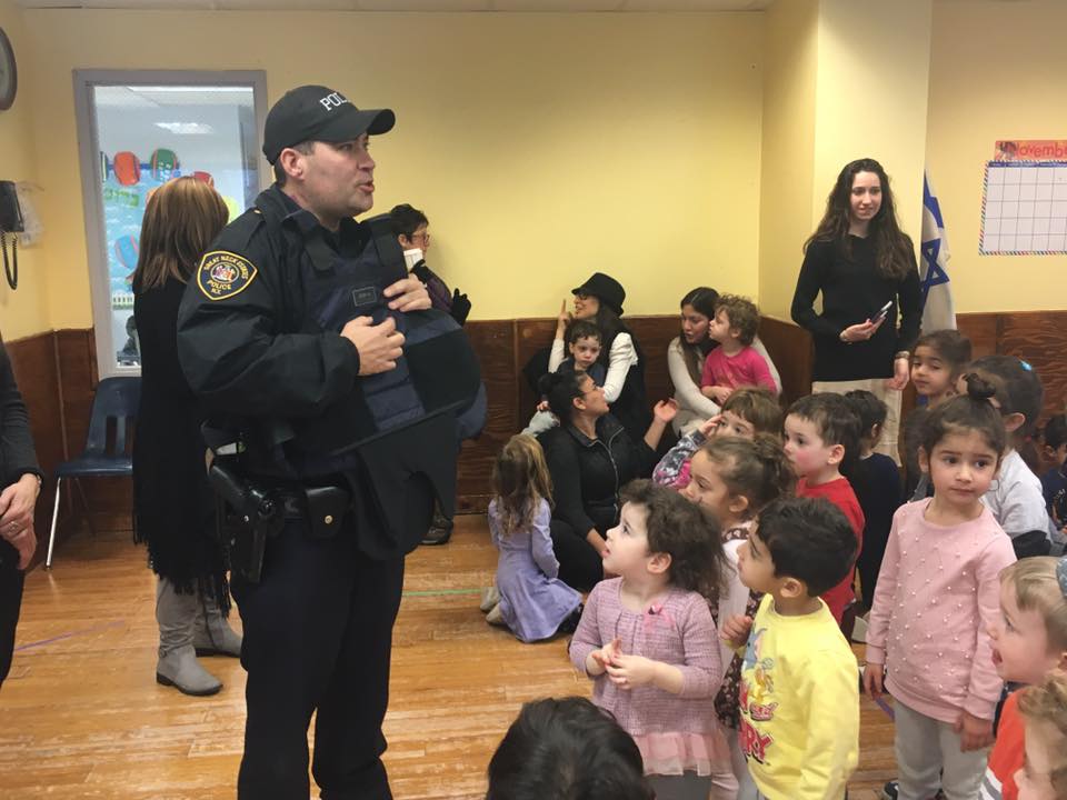 Silverstein Hebrew Academy students listen as police officers from the Great Neck Estates Police Department explain the lifesaving nature of Kevlar vests, and some of the dangers police officers face on a daily basis. (Photo courtesy of Zimmerman/Edelson)