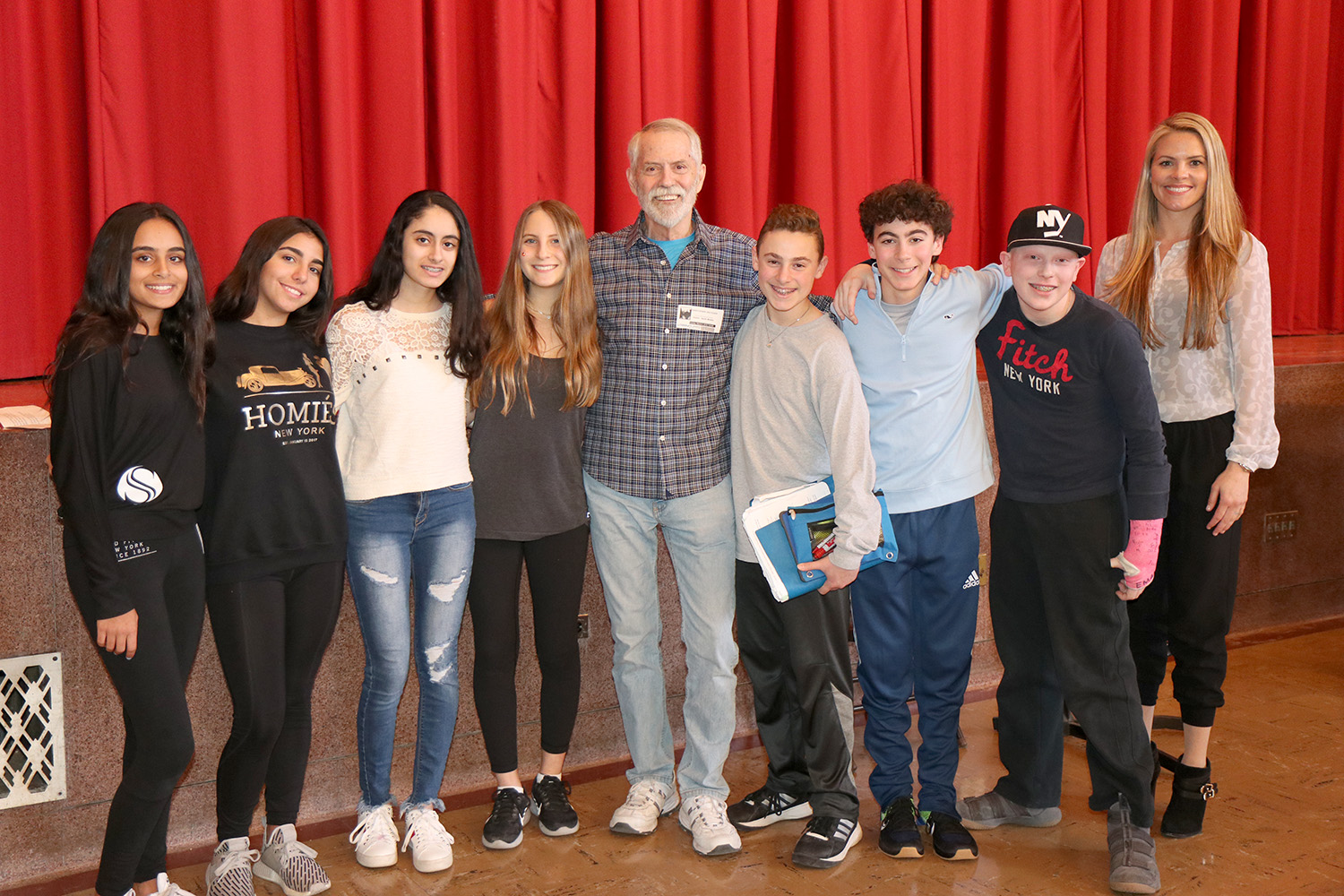 Author Chris Crutcher, in center, is joined by eighth-grade students and Cinthia Serowik, English department head at North Middle. (Photo courtesy of the Great Neck Public Schools)