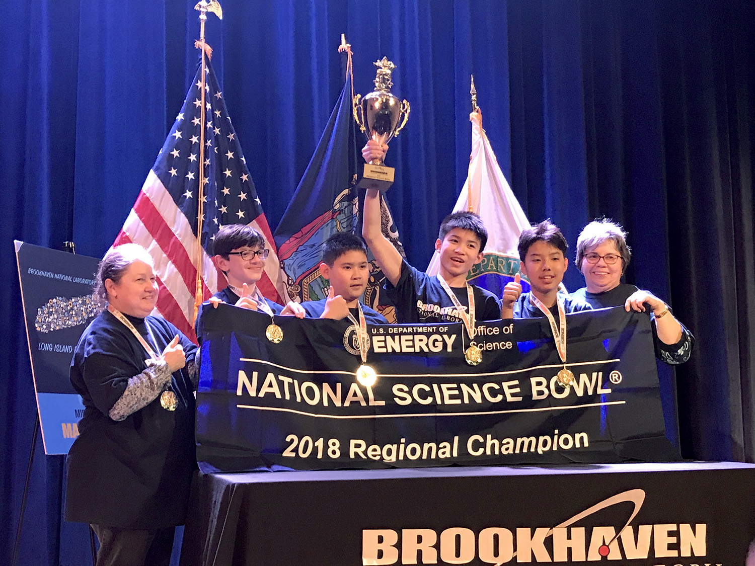 The South Middle team holds their Regional Science Bowl banner and trophy. (Photo courtesy of the Great Neck Public Schools)