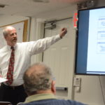 Village Clerk-Treasurer Joe Gill discusses the $9.67 million budget at a Tuesday night board meeting. (Photo by Janelle Clausen)