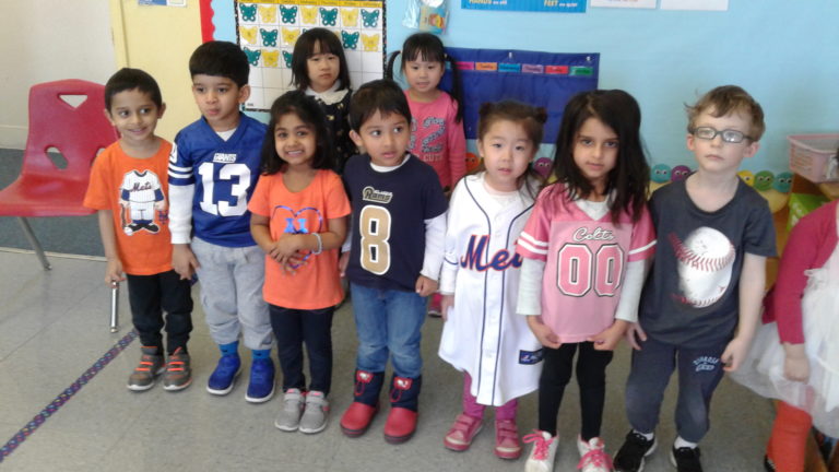 Preschoolers foot for home teams on sports shirt day