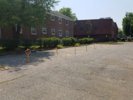 The southern parking lot of Millbrook Court remains largely empty, save for cones, rope, and a single vehicle. (Photo by Janelle Clausen)