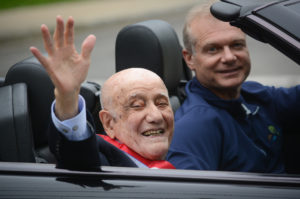 Mort Zimmerman, the grand marshal of the 2018 parade, waves to a crowd of spectators. (Photo by Janelle Clausen)