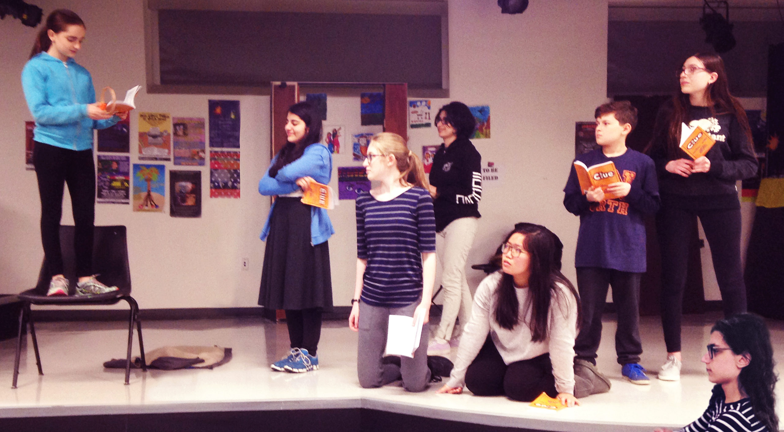 Dana Kagan, Sara Rafaeil, Phoebe Gordon, Sara Chitsaz, Joy Chang, Jack Brenner, Simona Fine and Julian Malater, the cast of “CLUE: The Musical” rehearse for their May and June performances. (Photo courtesy of the Great Neck Library)