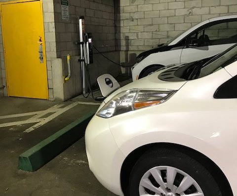 The village's 2017 Nissan Leaf, an electric car, sits parked at a public charging station in a garage. (Photo courtesy of Great Neck Plaza)