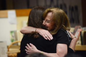 Retiring Principal Debbie Shalom embraces Staci Solomon, an elementary school teacher who was recently approved to receive tenure. (Photo by Janelle Clausen)