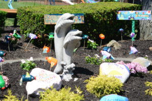 Dolphins, signs, and newly painted rocks now adorn the garden. (Photo by Janelle Clausen)
