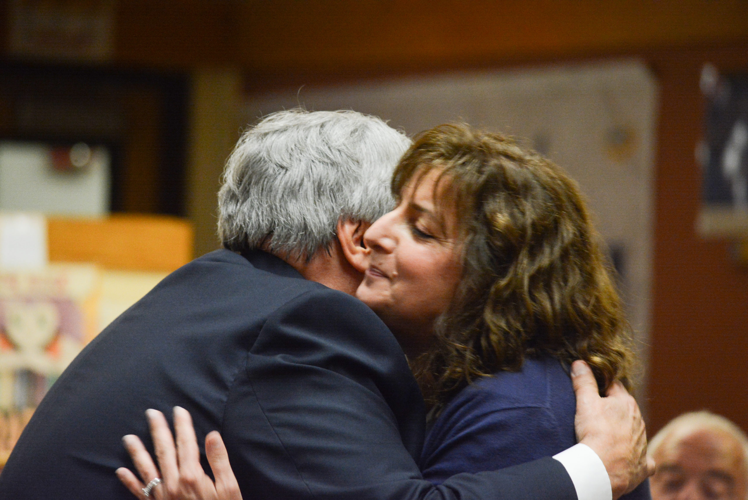 South Middle School Principal James Welsch embraces Carla Diesu, who was later approved for tenure. (Photo by Janelle Clausen)