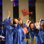 Great Neck South graduates throw their decorated caps into the air, celebrating a new chapter of their lives. (Photo by Janelle Clausen)