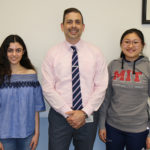 North High Principal Daniel Holtzman congratulates Courtney Hakimian and Megan Xu on being National Merit Scholars. (Photo courtesy of the Great Neck Public Schools)