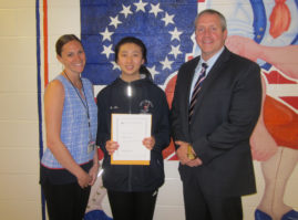 South High Principal Dr. Christopher Gitz and guidance counselor Gillian O’Connell congratulate Kimberly Lu. (Photo courtesy of the Great Neck Public Schools)