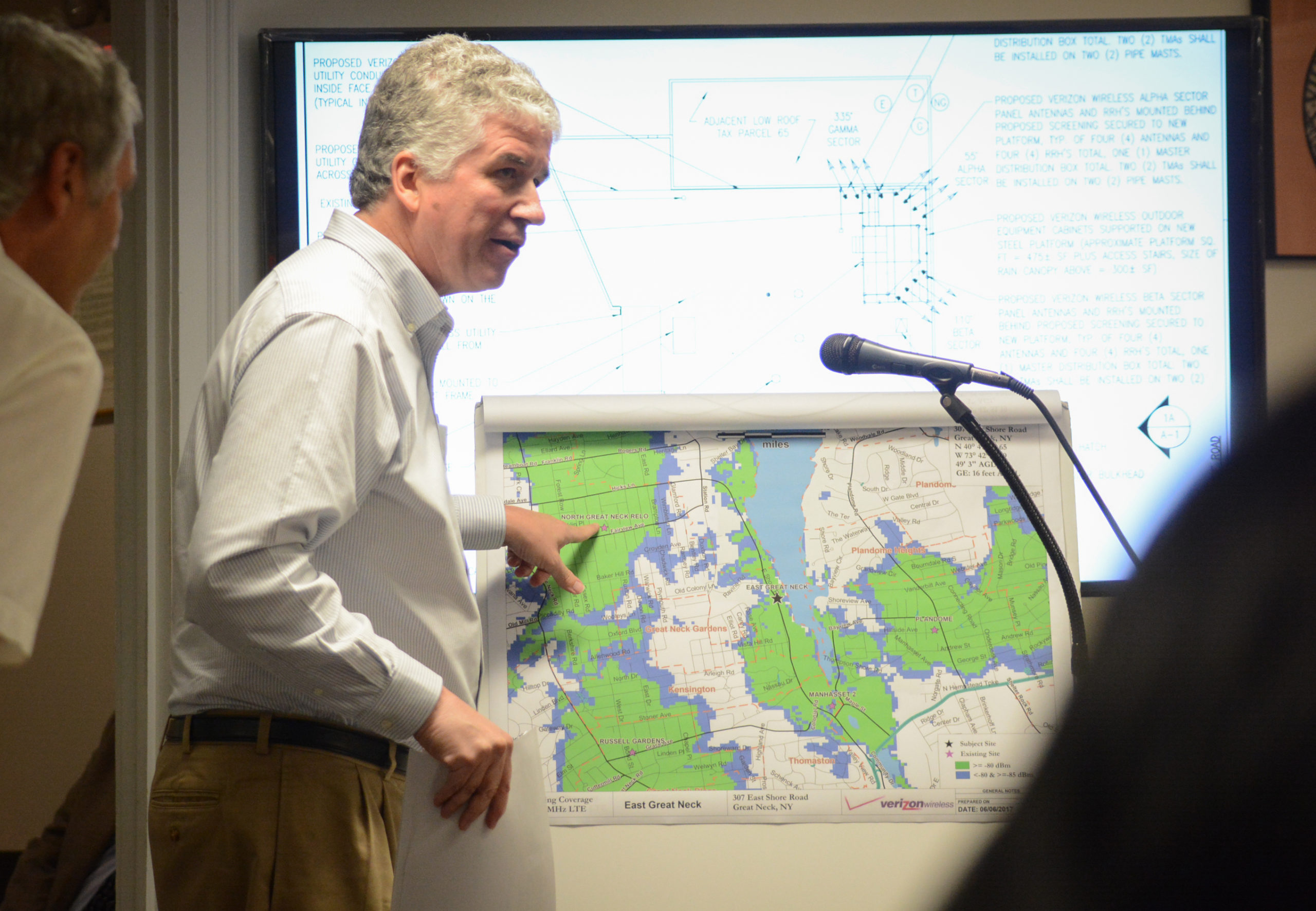 Martin Lavin, a radio frequency engineer with C-Squared Systems, gestures to coverage areas on a map. (Photo by Janelle Clausen)