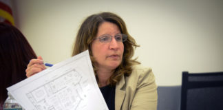 Great Neck Library Director Denise Corcoran reviews the final plans for the Station branch library. (Photo by Janelle Clausen)