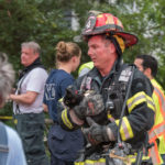 A firefighter from Vigilant Fire Company holds one of survivors from the house fire. (Photo courtesy of Over the Edge Photography)