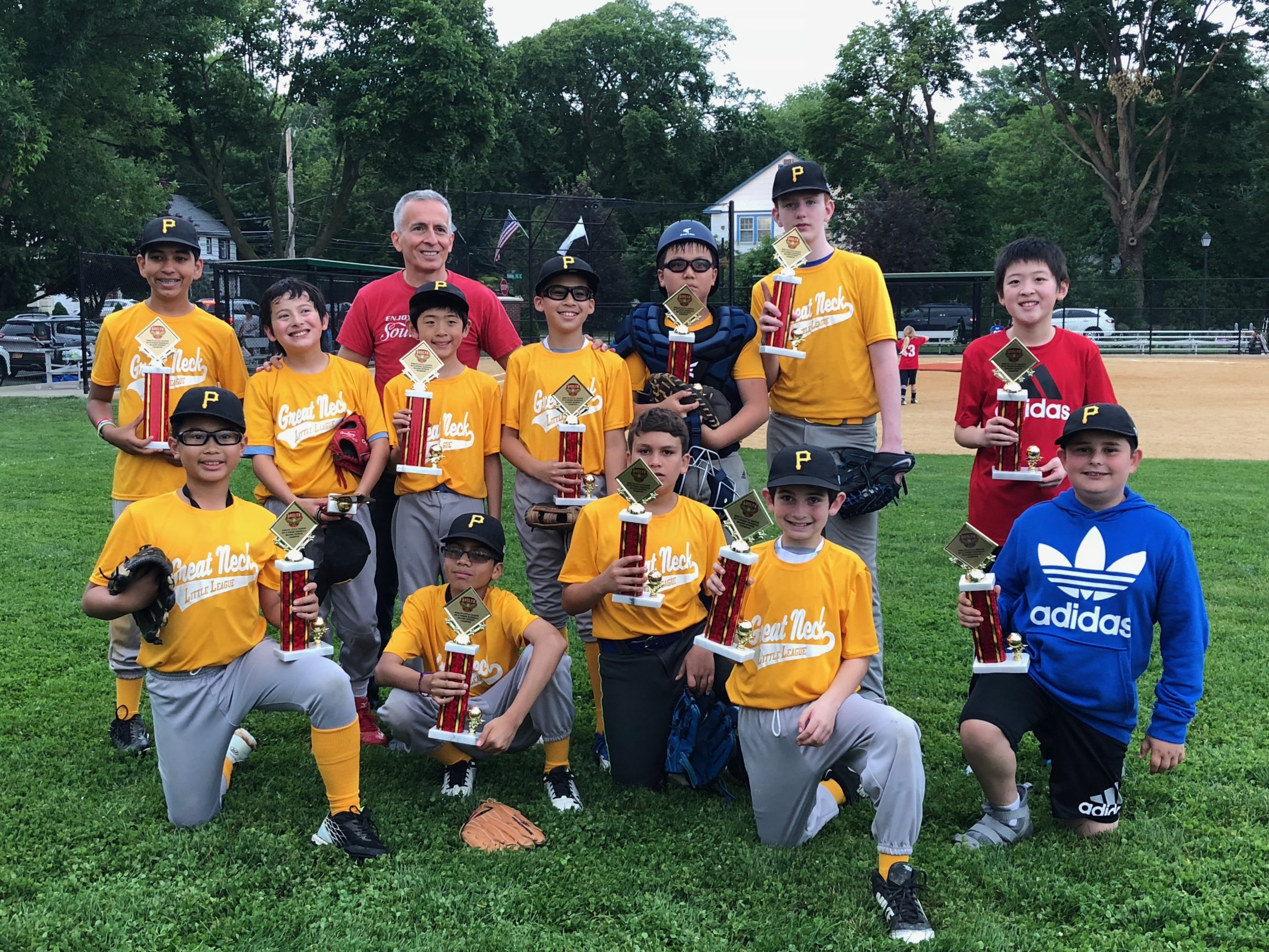 Jeremy Chuck, Eduardo Flores, Andrew Lentini, Noah Scheidt, Andrew Hirshbein, Aman Thawani, James Cenawood, Adrien Wei, Cooper Sang, William Ouyang, Richard Deem, Shaun Wei and Coach Sean Cenawood swept this year's Little League season. (Photo courtesy of the Pirates of Great Neck Little League)