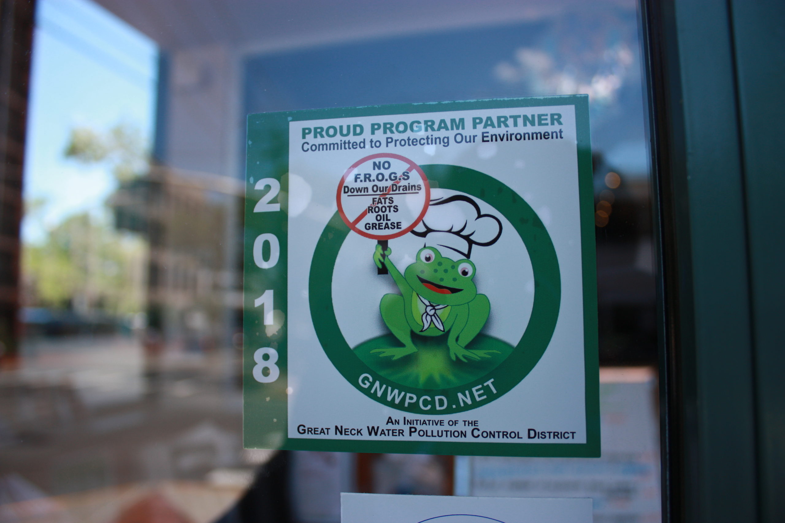 Great Neck Water Pollution Control District’s decal signifying that local restaurants dispose of cooking grease in an eco-friendly way. (Photo courtesy of the Great Neck Water Pollution Control District)