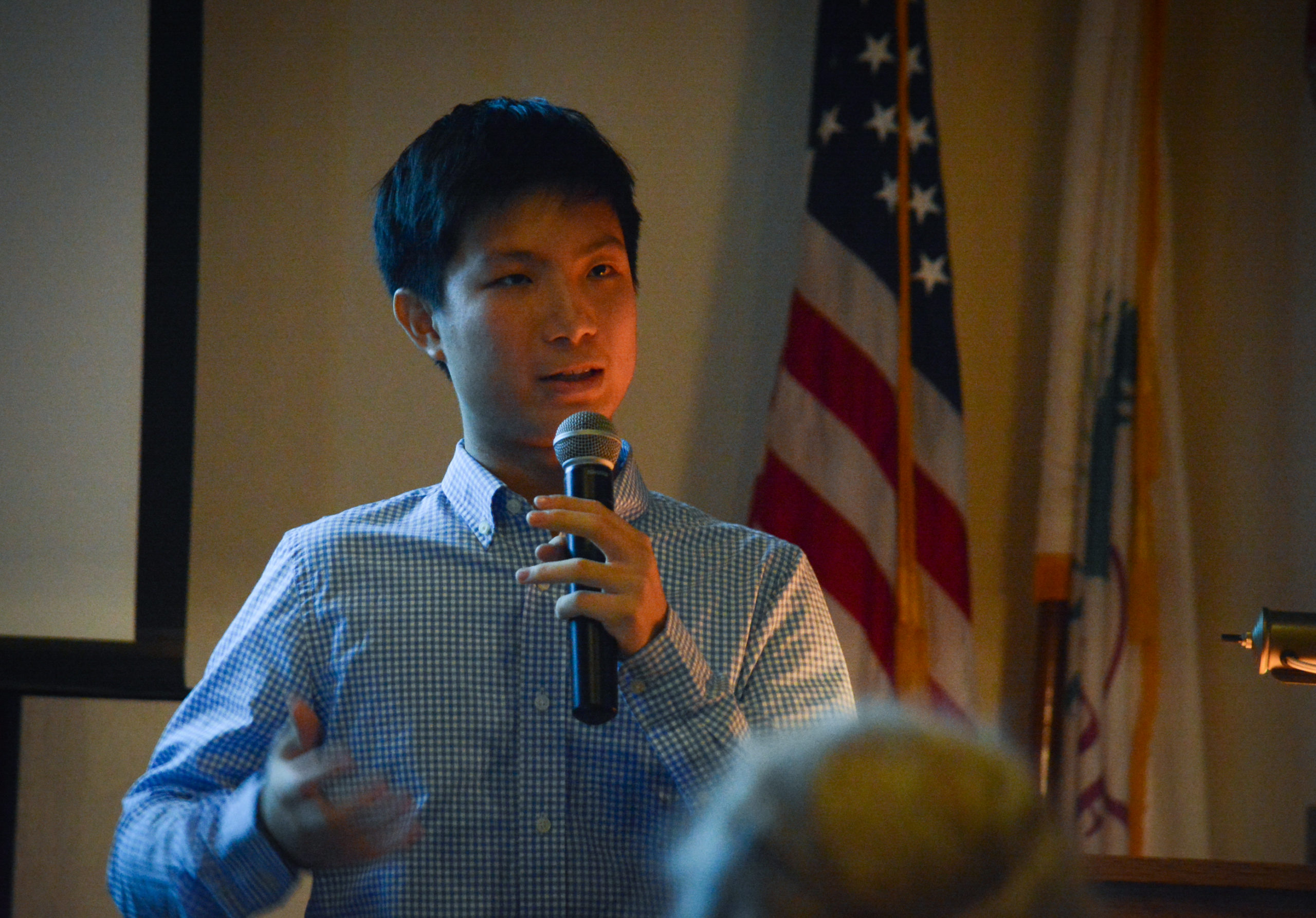 Raymond Lin answers questions from attendees at the Great Neck House about his and Abizadeh's research. (Photo by Janelle Clausen)
