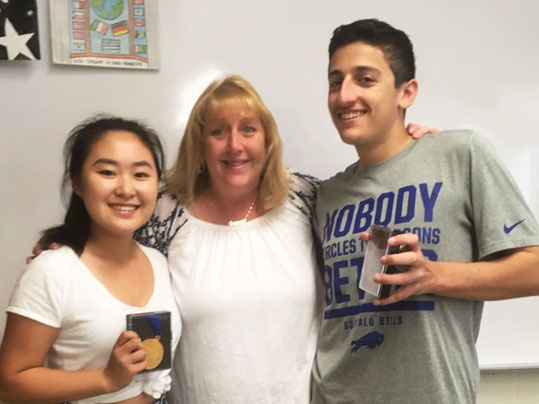 Award winners Annie Park and Spencer Horowitz of South High School are congratulated by American Sign Language teacher Kathy McAleer. (Photo courtesy of the Great Neck Public Schools)