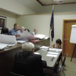 Architect Ronald Zakary reviews the revised building plans for Tower Ford with Thomaston Mayor Steve Weinberg, center left, and the board. (Photo by Samuel Glasser)