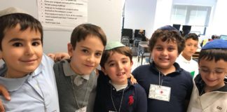 Silverstein Hebrew Academy second graders with their medical badges after they performed their contraction surgeries. (Photo courtesy of Silverstein Hebrew Academy)