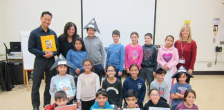 Students in Jessica Citrin and Shari Rich’s fourth-grade class are photographed with library media specialist Andrea Gerstenblatt and author and illustrator Chris Soentpiet. (Photo courtesy of the Great Neck Public Schools)