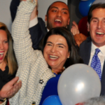 Anna Kaplan, flanked by Hempstead Supervisor Laura Gillen and state Sen. Todd Kaminsky, is declared the victor of the state Senate District 7 race at the Democrats' election party in Garden City. (Photo by Luke Torrance)