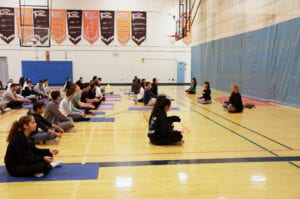 Yoga instructors Lisa Bondy, Andrea Weisban, and Missy Leder from the Center for Wellness & Integrative Medicine led students through yoga movements to help improve focus, concentration, and mindfulness. (Photo courtesy of the Great Neck Public Schools)