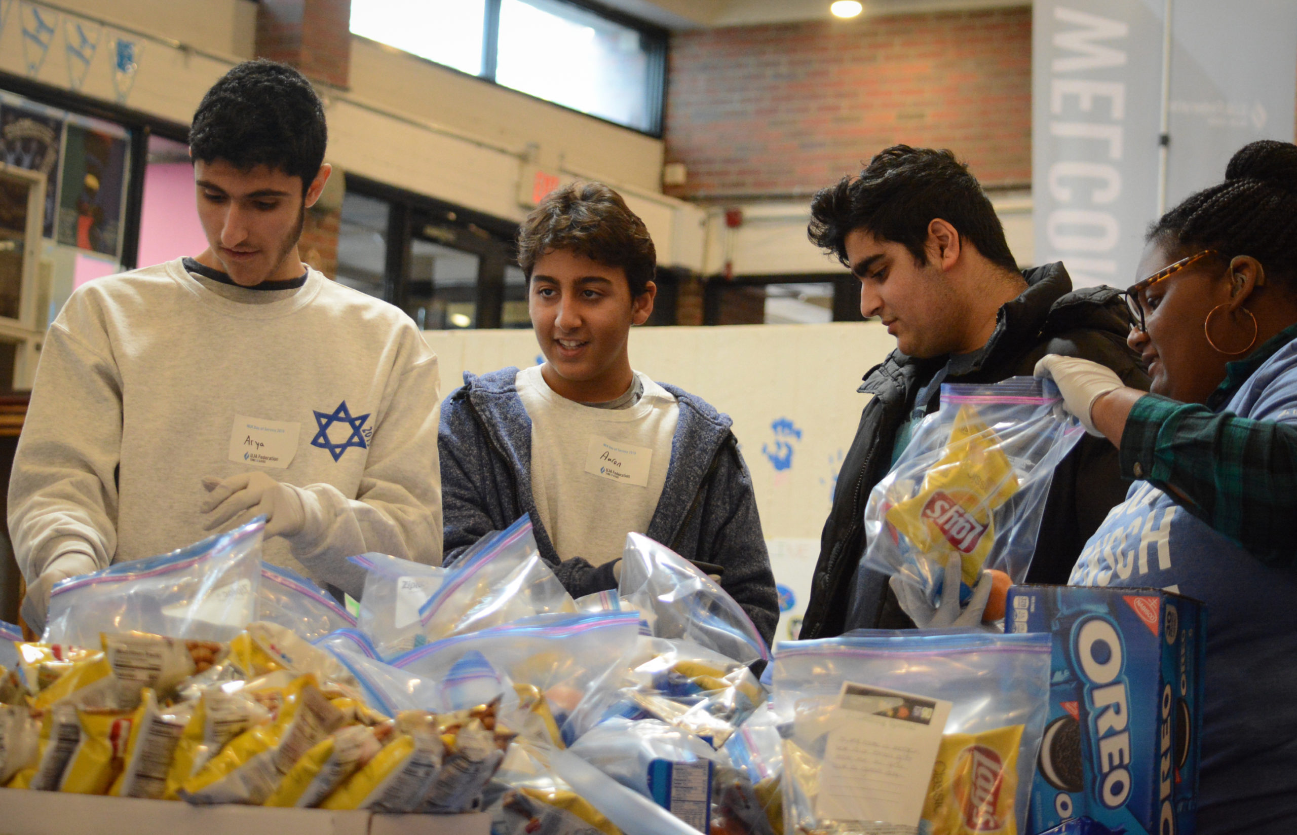 A group of teens work together to assemble bags of goods for the Interfaith Nutrition Network as part of the Martin Luther King Day of Service. (Photo by Janelle Clausen)
