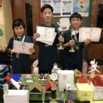 Great Neck South Middle School students Arthur Zhang, Richard Oh, and Ivan Xu are photographed with their certificates and trophies from the regional Future City Competition on Jan. 19. (Photo courtesy of the Great Neck Public Schools)