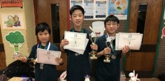 Great Neck South Middle School students Arthur Zhang, Richard Oh, and Ivan Xu are photographed with their certificates and trophies from the regional Future City Competition on Jan. 19. (Photo courtesy of the Great Neck Public Schools)