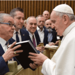 Assemblyman Anthony D'Urso, pictured here with Great Neck lawyer Michael Weinstock and State Comptroller Tom DiNapoli of Great Neck, hands a bound copy of a diary that corroborates how D'Urso's family protected a Jewish family during World War II to Pope Francis. (Photo courtesy of Michael Weinstock)