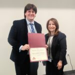 Library Director Denise Corcoran presents the Great Neck Library Staff Excellence Award certificate to recipient Christopher Van Wickler. (Photo courtesy of the Great Neck Library)