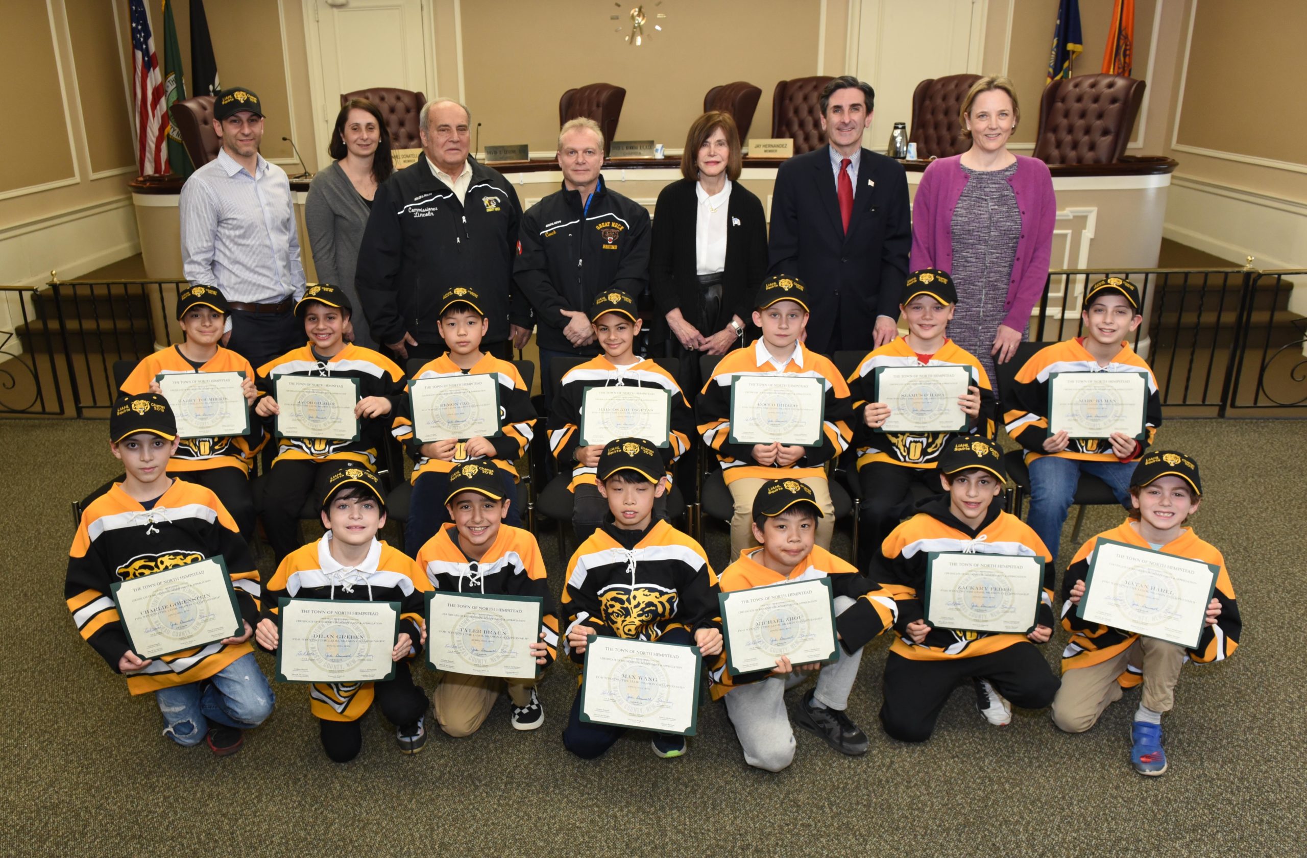 Superintendent Jason R. Marra, Commissioners Tina Stellato, Robert Lincoln, Jr., Frank Cilluffo, Council Member Lee Seeman, Town Clerk Wayne Wink and Council Member Veronica Lurvey are pictured with the victorious Great Neck Bruins. (Photo courtesy of the Town of North Hempstead)