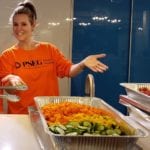 PSEG Long Island employee volunteer Kim Kaiman of Great Neck is all smiles after preparing a brunch spread to help families at the Ronald McDonald House in New Hyde Park. (Photo courtesy of PSEG Long Island)