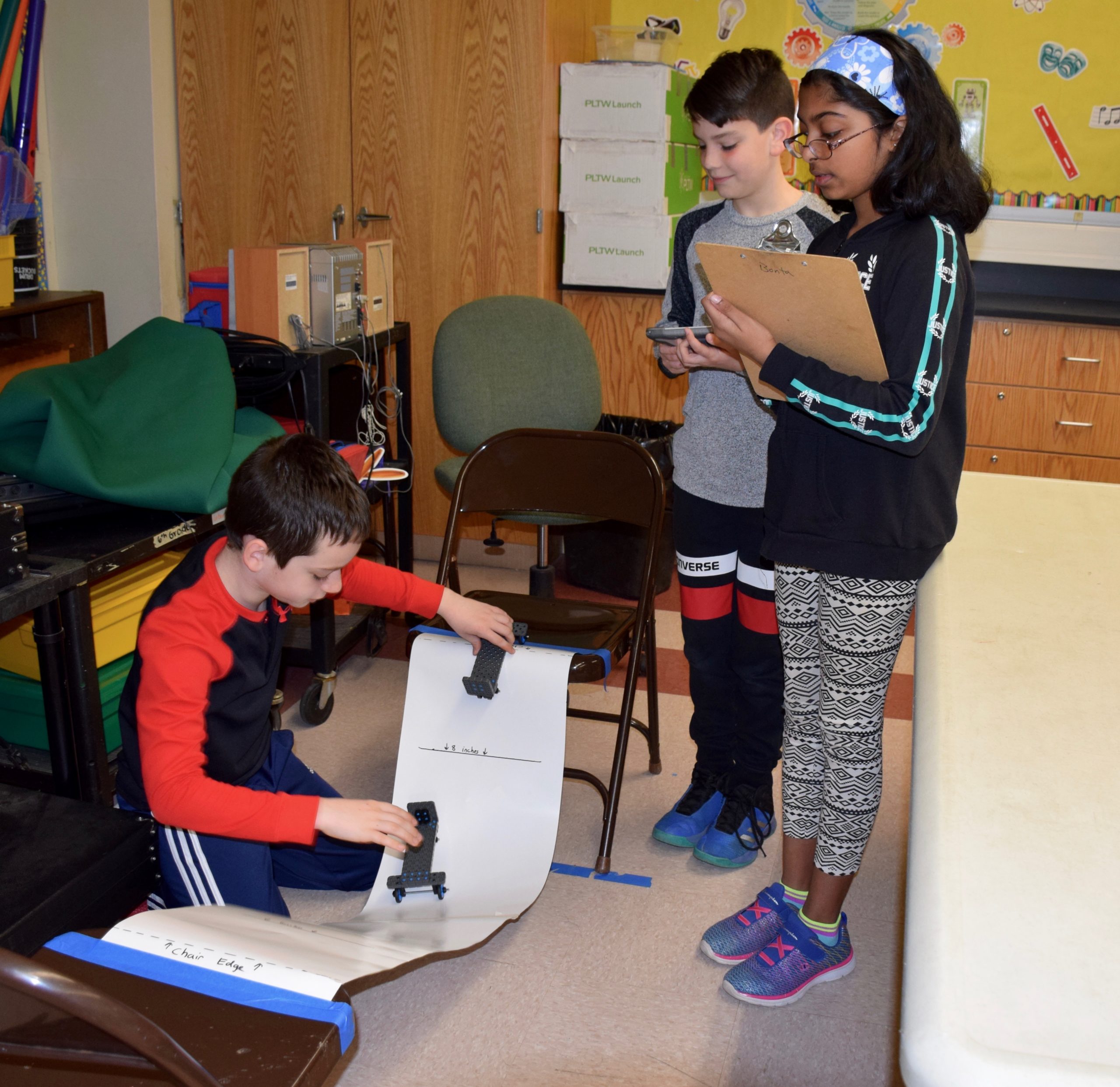 Manor Oaks School students Mateo Mrakovcic (left), Alexander Fulgieri and Meera Lal (right) teamed up to test collisions during an Energy and Collision module. (Photo courtesy of the New Hyde Park-Garden City school district)