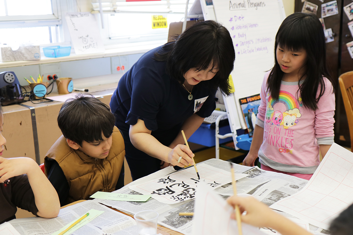 Angela Pian teaches Chinese Calligraphy to Ms. Seiden’s third-grade class as part of the Lakeville School’s annual Teach-In event. (Photo courtesy of Great Neck Public Schools)