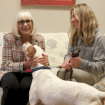 Town Supervisor Judi Bosworth, pictured here with North Hempstead Animal Shelter Director Jenna Givargidze, pets Royal, a dog at the North Hempstead Animal Shelter. (Video still from Town of North Hempstead YouTube)