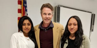 Jakeline Arevalo and Melissa Ceron are congratulated by South High guidance counselor Christopher Erickson. (Photo courtesy of Great Neck Public Schools)