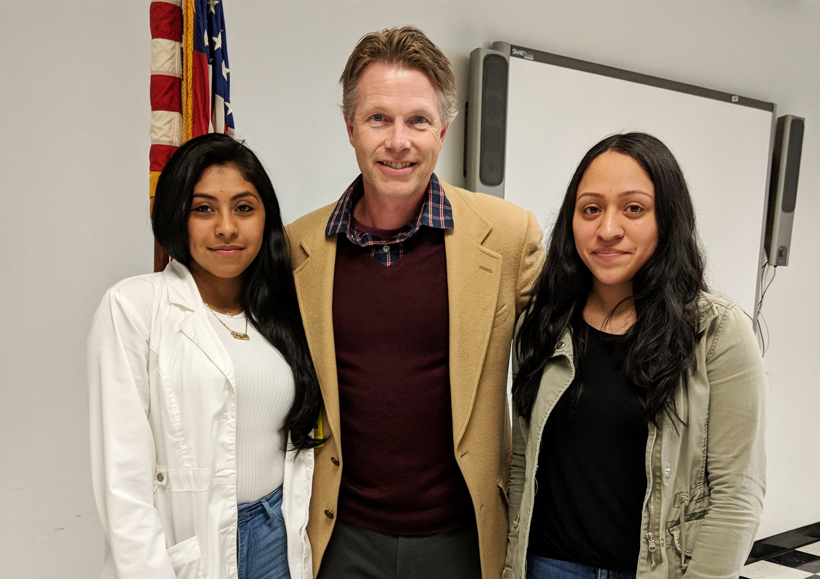 Jakeline Arevalo and Melissa Ceron are congratulated by South High guidance counselor Christopher Erickson. (Photo courtesy of Great Neck Public Schools)