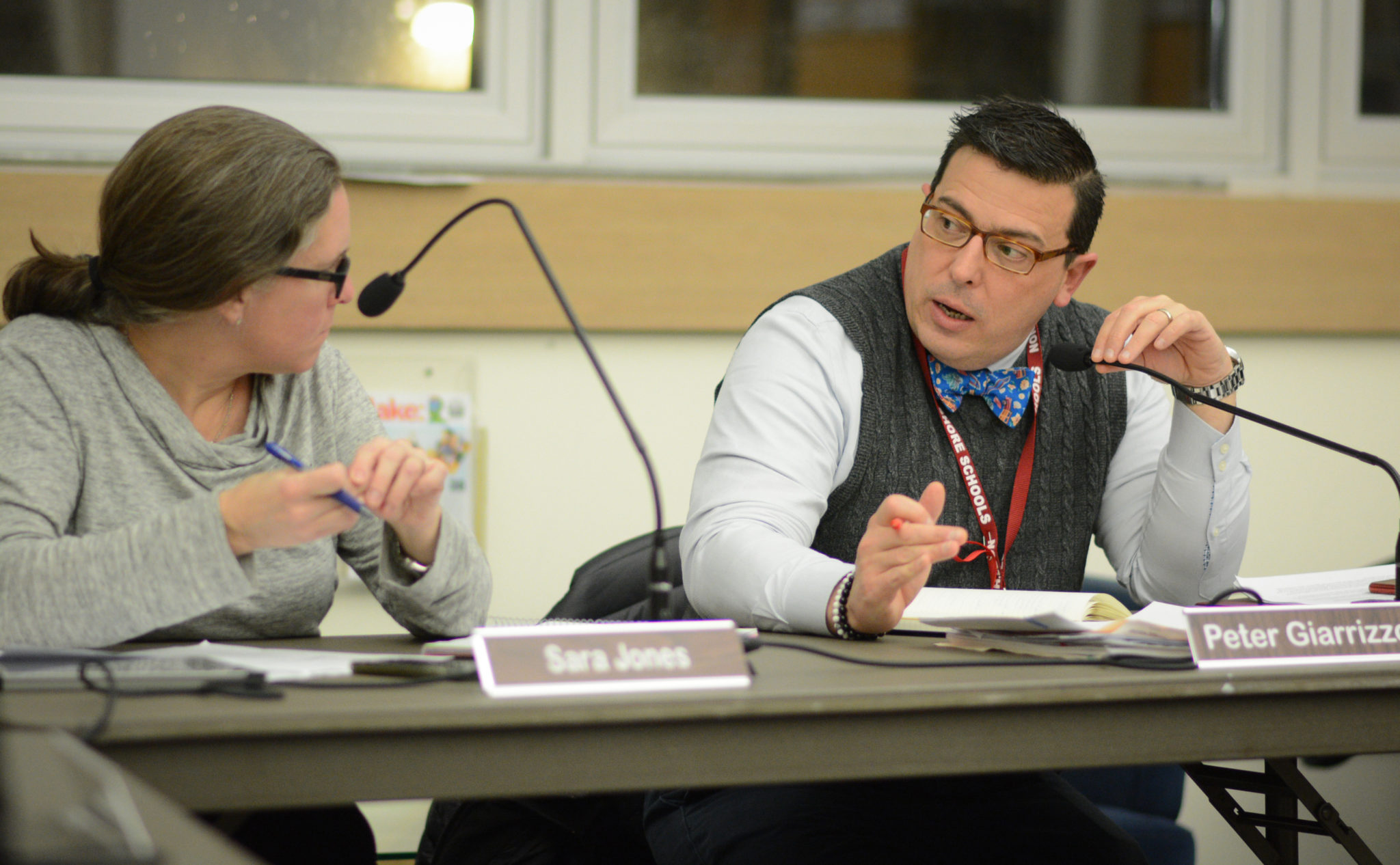 North Shore Superintendent of Schools Peter Giarrizzo speaks with Sara Jones, the school board president, during a business meeting about the impact of a possible settlement between LIPA and Nassau County. (Photo by Janelle Clausen)