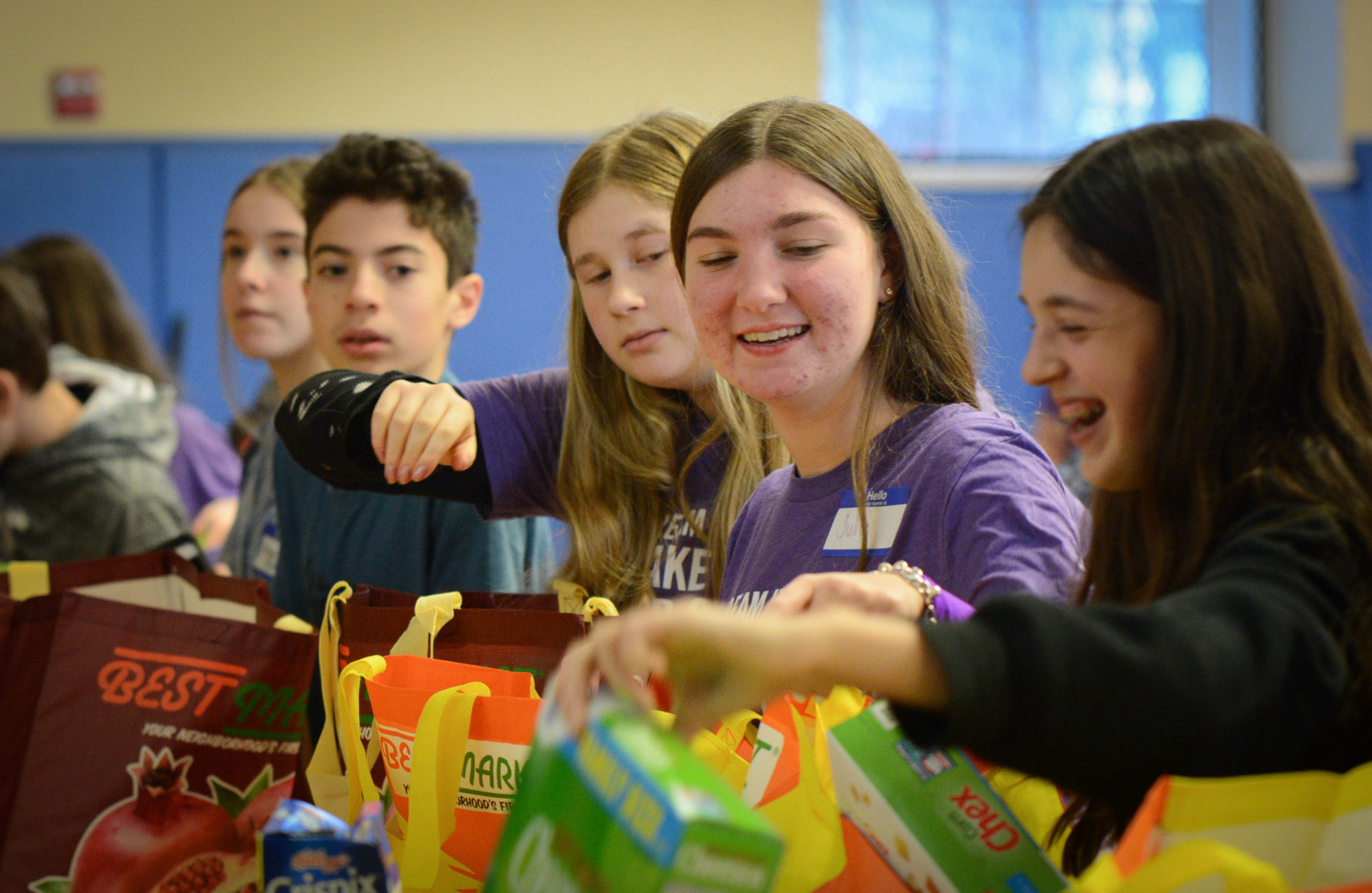 Great Neck teens lined up to assemble packages for low-income families on Monday, as part of a day of service on Martin Luther King day. (Photo by Janelle Clausen)