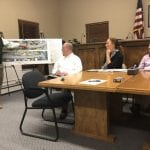 Project lead Gil Anderson, left, presents the plans for Manorhaven Boulevard, as Nassau County Public Works Commissioner Ken Arnold, Nassau County Legislator Delia DeRiggi-Whitton and Manorhaven Mayor Jim Avena look on at a 2019 meeting regarding the plans. (Photo by Rose Weldon)